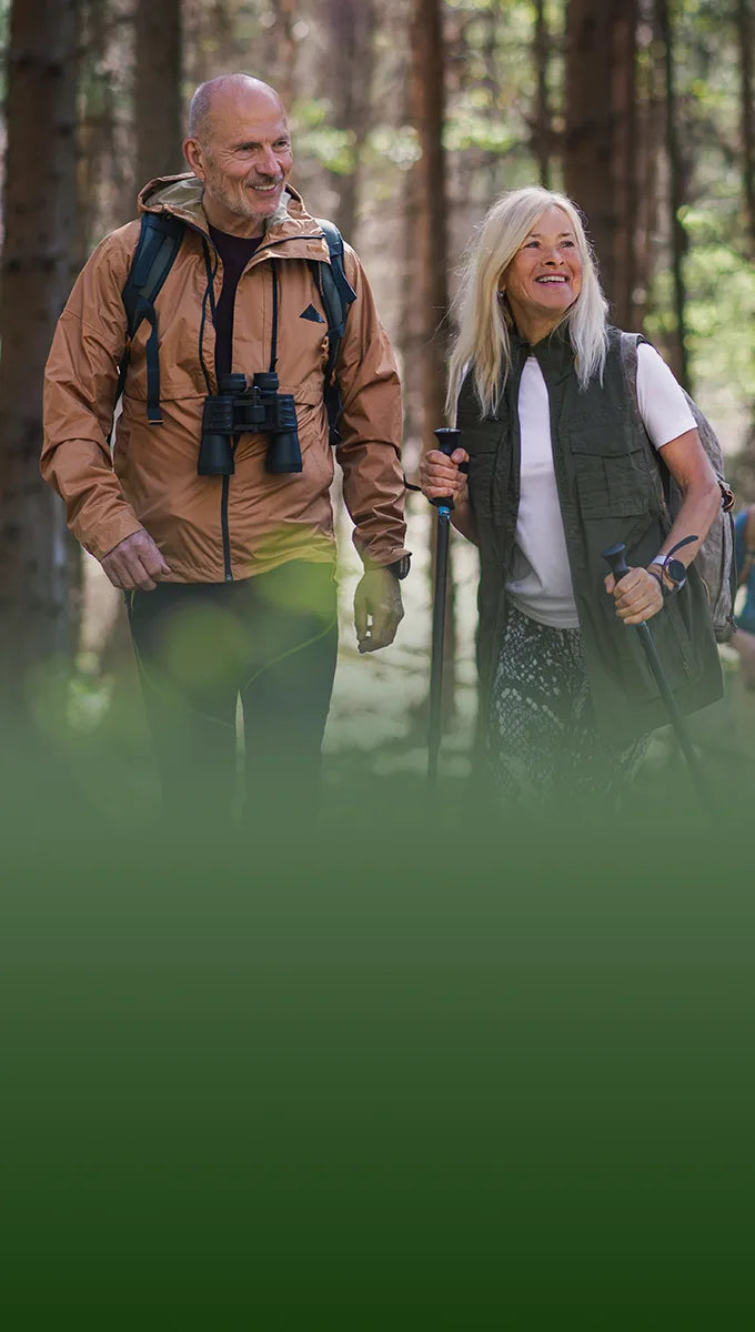 Active seniors hiking in a forest, representing healthy lifestyle benefits of CBD for adults over 55