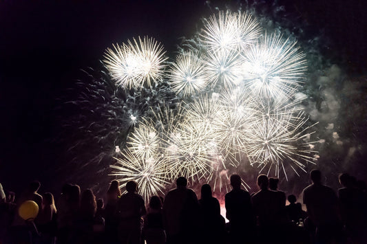 Crowd of active adults watching fireworks to ring in new year