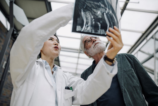 Female doctor going over bladder xray with senior patient