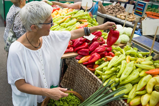 Senior woman shopping fresh vegetables for holistic diet
