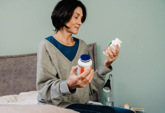 Senior woman taking cbd softgels in bedroom